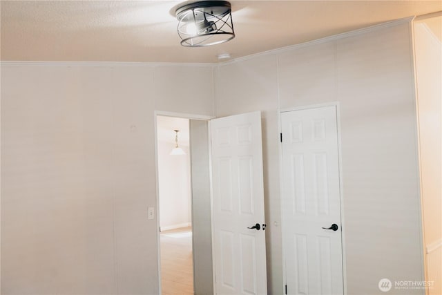 8805 226th Street Ct E Unit 32, Graham, WA 98338 - unfurnished bedroom featuring ornamental molding and light wood-type flooring