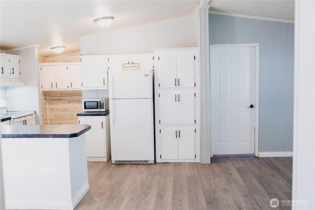 8805 226th Street Ct E Unit 32, Graham, WA 98338 - kitchen featuring white appliances, exhaust hood, white cabinetry, vaulted ceiling, and light wood-style flooring