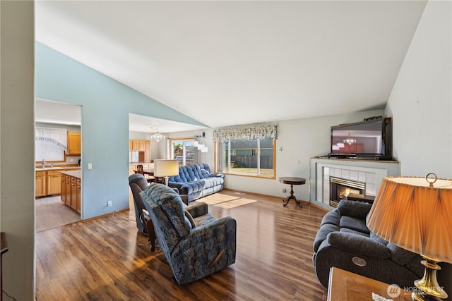 3519 G Ave, Anacortes, WA 98221 - living area with vaulted ceiling, wood finished floors, a tile fireplace, and a chandelier