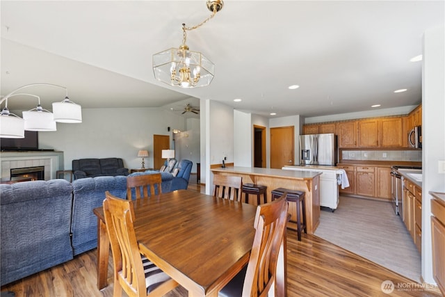 3519 G Ave, Anacortes, WA 98221 - dining area featuring ceiling fan, light wood finished floors, recessed lighting, a tile fireplace, and a chandelier