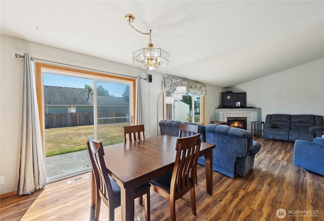 3519 G Ave, Anacortes, WA 98221 - dining space with a chandelier, wood finished floors, and a fireplace