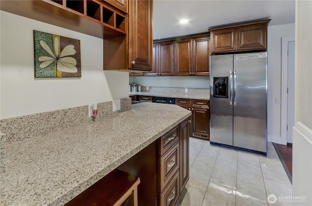 418 Jefferson St, Centralia, WA 98531 - kitchen with stainless steel fridge with ice dispenser, light stone counters, light tile patterned floors, dark brown cabinetry, and recessed lighting