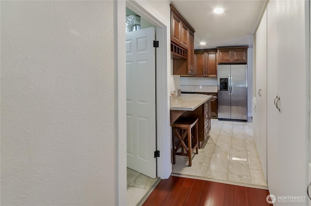 418 Jefferson St, Centralia, WA 98531 - kitchen with stainless steel fridge, light wood-type flooring, recessed lighting, and a kitchen breakfast bar