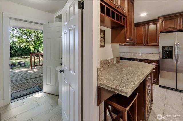 418 Jefferson St, Centralia, WA 98531 - kitchen with stainless steel fridge, light stone countertops, light tile patterned flooring, and open shelves