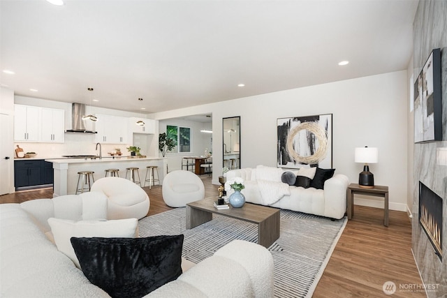 1515 243rd Pl SW Unit A, Bothell, WA 98012 - living area featuring a premium fireplace, light wood finished floors, and recessed lighting