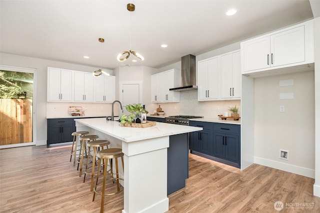 1515 243rd Pl SW Unit A, Bothell, WA 98012 - kitchen with wall chimney exhaust hood, a breakfast bar area, tasteful backsplash, light wood-type flooring, and recessed lighting