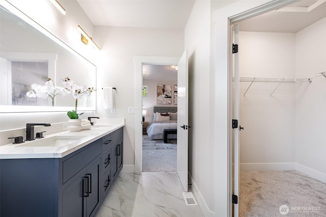 1515 243rd Pl SW Unit A, Bothell, WA 98012 - ensuite bathroom featuring double vanity, marble look tiles, and a spacious closet