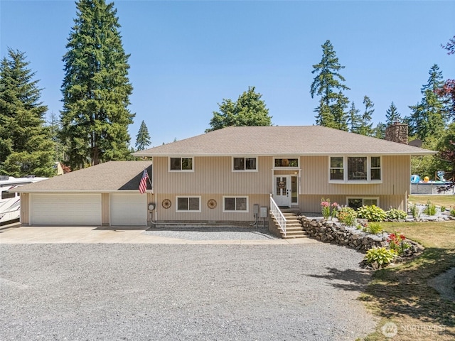20311 Orting Kapowsin Hwy E, Graham, WA 98338 - bi-level home featuring french doors, driveway, an attached garage, a chimney, and a shingled roof