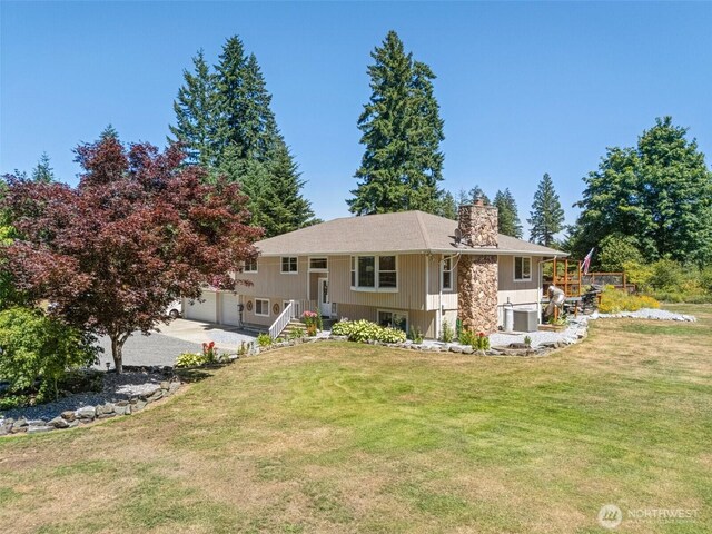 20311 Orting Kapowsin Hwy E, Graham, WA 98338 - view of front facade with a chimney, a front yard, and a garage