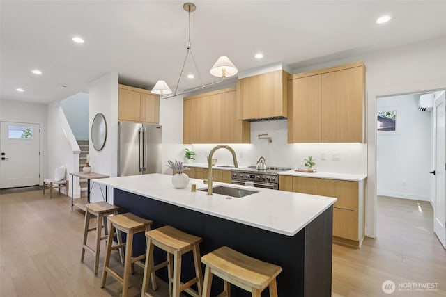 11737 38th Ave NE Unit A, Seattle, WA 98125 - kitchen with modern cabinets, stainless steel appliances, light brown cabinetry, light countertops, and light wood-style flooring