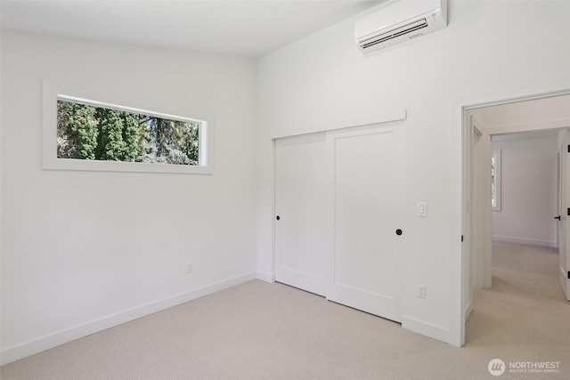 11737 38th Ave NE Unit A, Seattle, WA 98125 - unfurnished bedroom featuring a wall unit AC, light colored carpet, and a closet