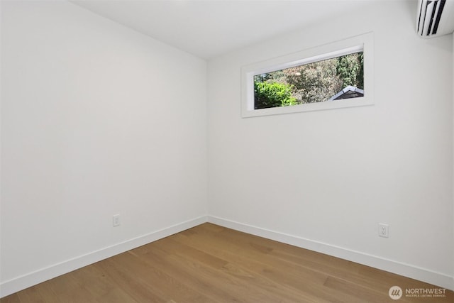 11737 38th Ave NE Unit A, Seattle, WA 98125 - empty room with an AC wall unit and light wood-style flooring