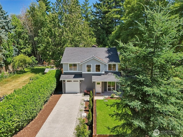11737 38th Ave NE Unit A, Seattle, WA 98125 - traditional-style house with decorative driveway, a shingled roof, an attached garage, and a front yard