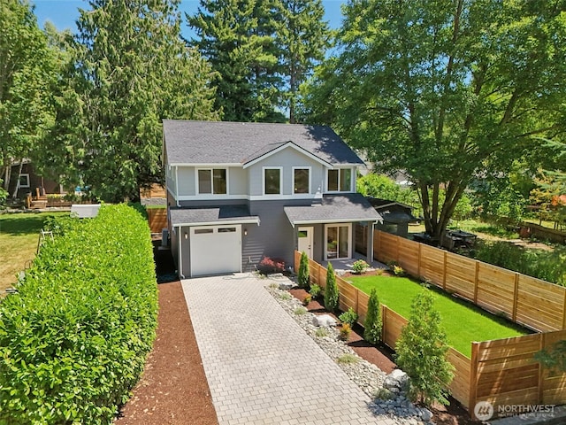 11737 38th Ave NE Unit A, Seattle, WA 98125 - view of front of home featuring decorative driveway, an attached garage, and a shingled roof