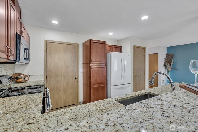 1302 110th St E Unit 37, Tacoma, WA 98445 - kitchen with freestanding refrigerator, electric range oven, light stone countertops, recessed lighting, and decorative backsplash