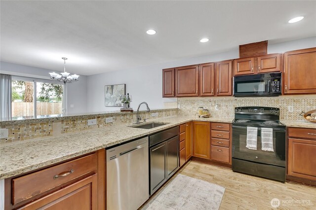 1302 110th St E Unit 37, Tacoma, WA 98445 - kitchen featuring black appliances, light stone countertops, light wood finished floors, backsplash, and recessed lighting