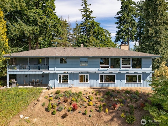 118 Highland Dr, Bellingham, WA 98225 - back of property featuring a chimney, a patio, and roof with shingles