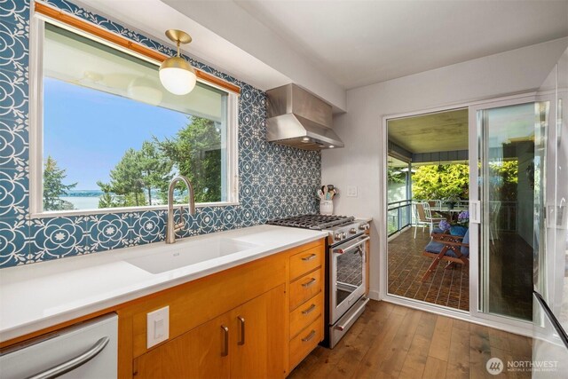 118 Highland Dr, Bellingham, WA 98225 - kitchen featuring stainless steel gas range oven, range hood, dishwasher, dark wood-style floors, and light countertops