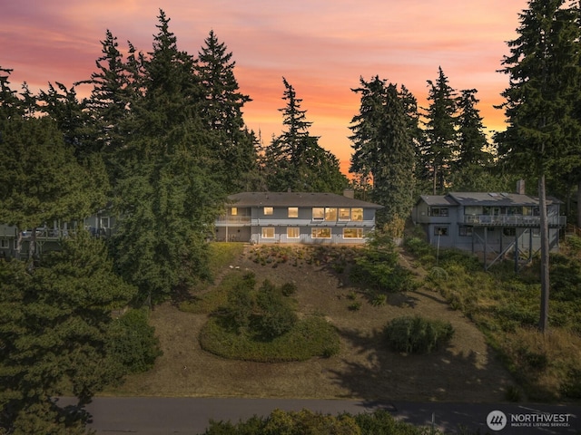 118 Highland Dr, Bellingham, WA 98225 - back of property at dusk with view of scattered trees and a balcony