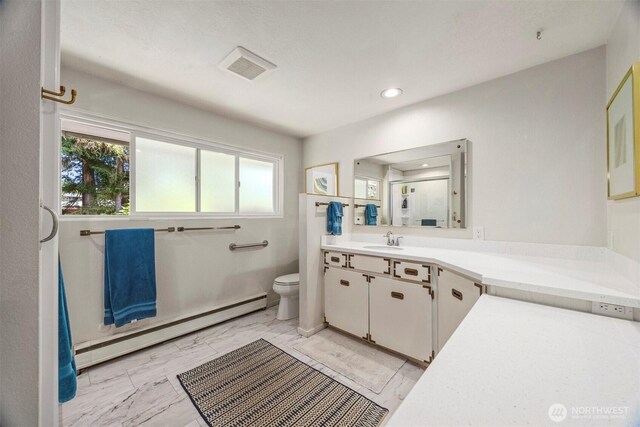 118 Highland Dr, Bellingham, WA 98225 - bathroom with baseboard heating, marble finish flooring, vanity, and recessed lighting