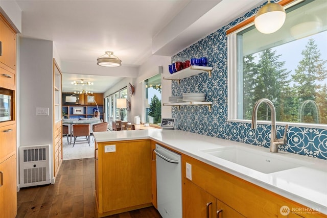 118 Highland Dr, Bellingham, WA 98225 - kitchen featuring white dishwasher, a peninsula, dark wood-style flooring, light countertops, and brown cabinets