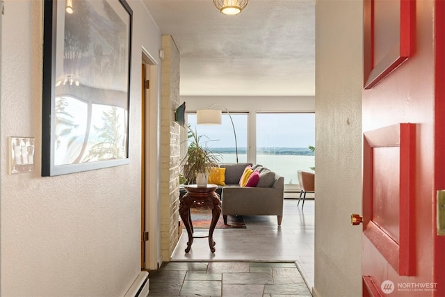 118 Highland Dr, Bellingham, WA 98225 - hallway with a textured wall, a baseboard heating unit, and a water view