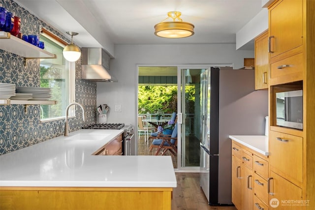 118 Highland Dr, Bellingham, WA 98225 - kitchen with stainless steel appliances, wall chimney exhaust hood, healthy amount of natural light, and tasteful backsplash