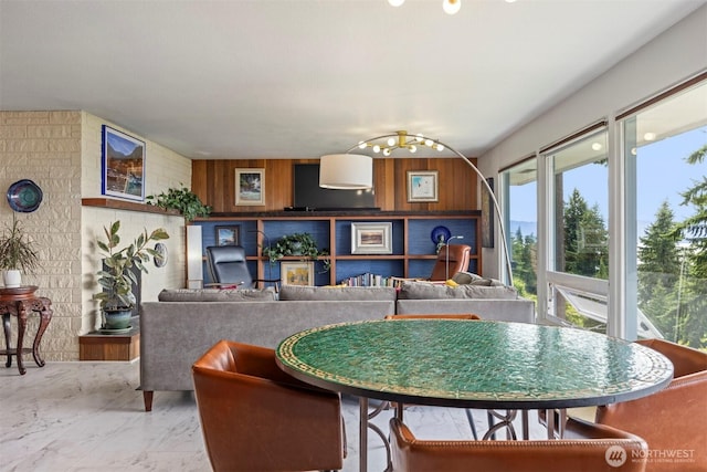 118 Highland Dr, Bellingham, WA 98225 - dining space with a chandelier, marble finish flooring, and wooden walls