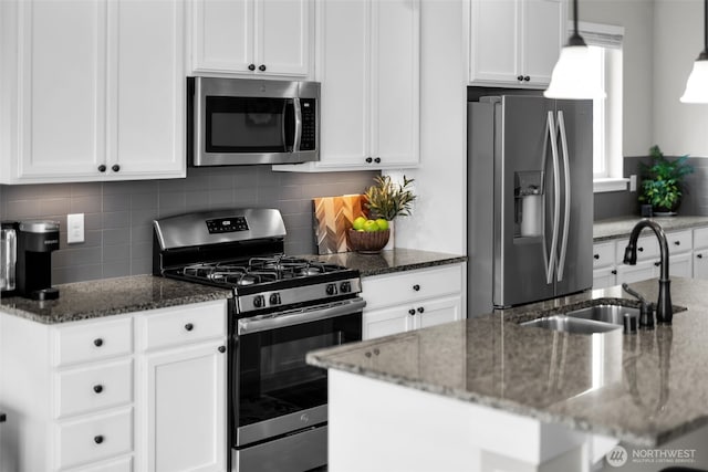 397 N Foster St, Buckley, WA 98321 - kitchen with stainless steel appliances, white cabinetry, dark stone counters, and tasteful backsplash