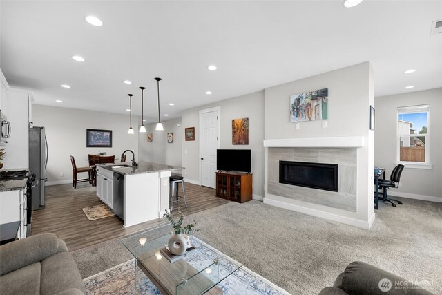 397 N Foster St, Buckley, WA 98321 - living room with recessed lighting, a tiled fireplace, and dark wood-type flooring