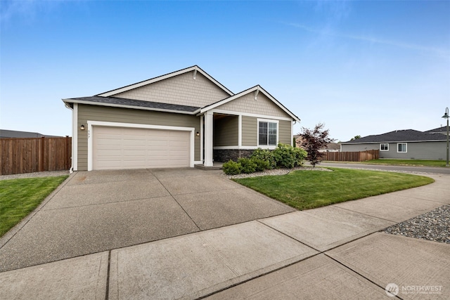 397 N Foster St, Buckley, WA 98321 - view of front facade featuring driveway, a garage, and stone siding