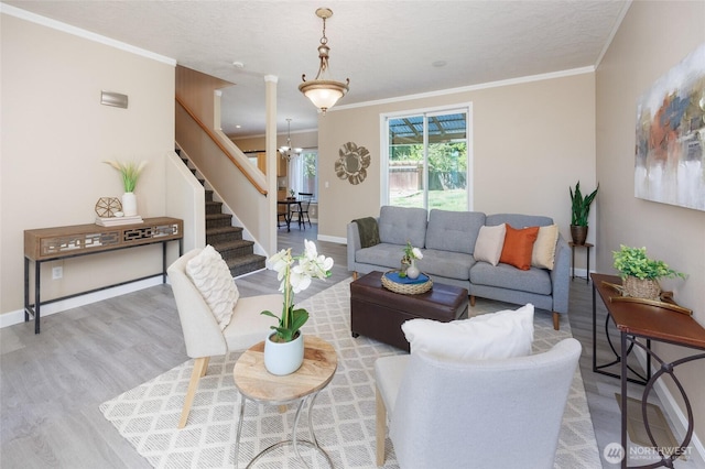 2537 Kristine Ct, Centralia, WA 98531 - living room featuring wood finished floors, stairway, a chandelier, and crown molding