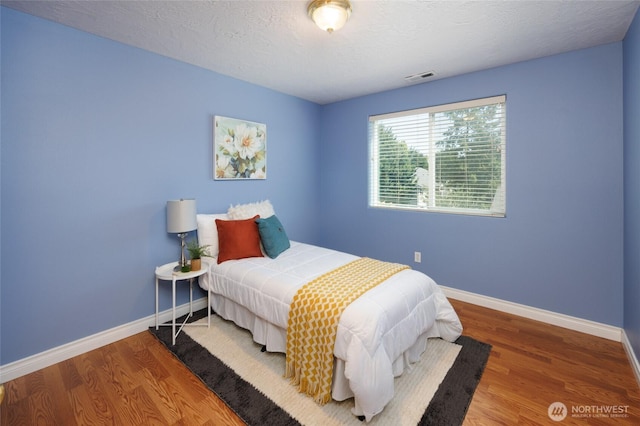 2537 Kristine Ct, Centralia, WA 98531 - bedroom with wood finished floors and a textured ceiling