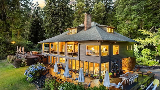 5222 Mahncke Rd SW, Longbranch, WA 98351 - back of property featuring outdoor dining space, a wooden deck, a shingled roof, a chimney, and a balcony