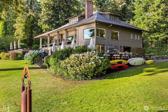 5222 Mahncke Rd SW, Longbranch, WA 98351 - view of side of home with a chimney, a lawn, stairway, and a shingled roof