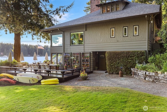 5222 Mahncke Rd SW, Longbranch, WA 98351 - rear view of house featuring a yard, a chimney, a deck, and roof with shingles