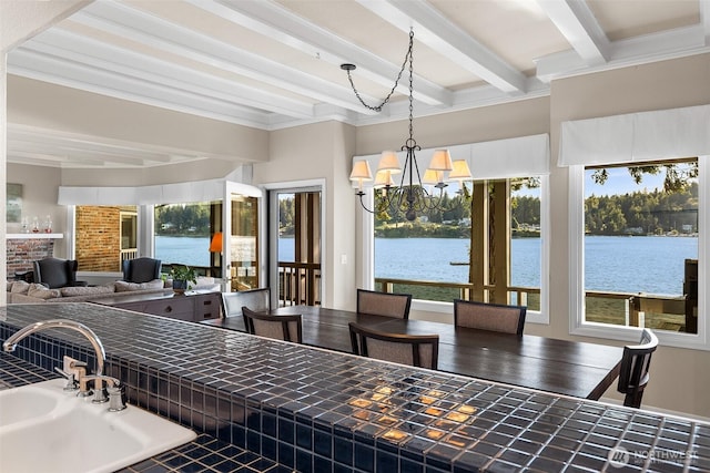 5222 Mahncke Rd SW, Longbranch, WA 98351 - sunroom with beamed ceiling, a chandelier, and a water view