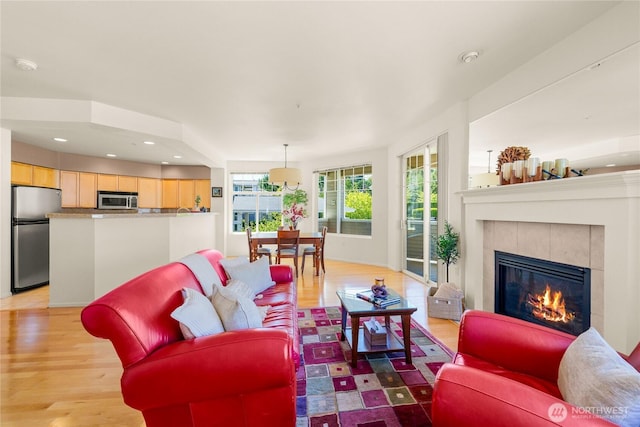 2244 SE 132nd Ave Unit B217, Bellevue, WA 98005 - living room with a tile fireplace, light wood finished floors, and recessed lighting