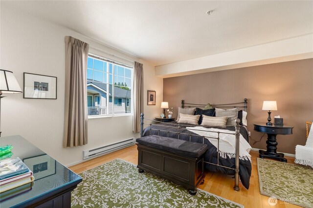 2244 SE 132nd Ave Unit B217, Bellevue, WA 98005 - bedroom featuring a baseboard heating unit and light wood-style flooring