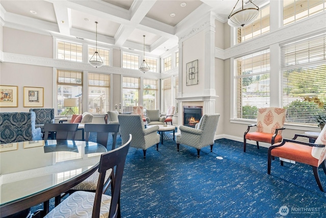 2244 SE 132nd Ave Unit B217, Bellevue, WA 98005 - dining area with a towering ceiling, carpet flooring, coffered ceiling, a glass covered fireplace, and beam ceiling