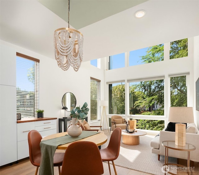2610 E Yesler Way Unit A, Seattle, WA 98122 - dining area featuring a high ceiling, a chandelier, light wood-type flooring, and recessed lighting
