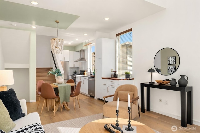2610 E Yesler Way Unit A, Seattle, WA 98122 - dining space featuring light wood finished floors, a chandelier, and recessed lighting