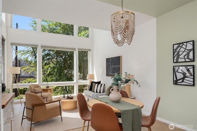 2610 E Yesler Way Unit A, Seattle, WA 98122 - dining area with a chandelier, a towering ceiling, and wood finished floors