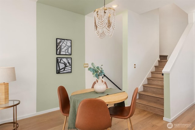 2610 E Yesler Way Unit A, Seattle, WA 98122 - dining area featuring light wood-style flooring, a chandelier, and stairway