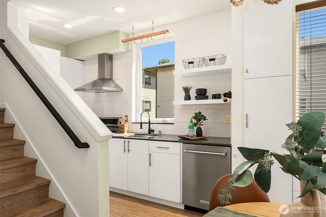 2610 E Yesler Way Unit A, Seattle, WA 98122 - kitchen with wall chimney range hood, stainless steel dishwasher, backsplash, dark countertops, and recessed lighting