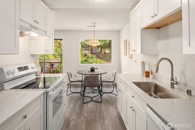 14132 74th Pl NE Unit 16D, Kirkland, WA 98034 - kitchen featuring white appliances, under cabinet range hood, white cabinets, dark wood-type flooring, and a textured ceiling