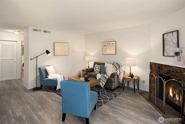 14132 74th Pl NE Unit 16D, Kirkland, WA 98034 - living area featuring wood finished floors and a stone fireplace