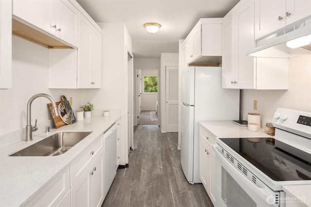 14132 74th Pl NE Unit 16D, Kirkland, WA 98034 - kitchen with white appliances, under cabinet range hood, white cabinets, and dark wood-type flooring