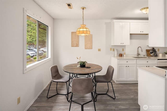14132 74th Pl NE Unit 16D, Kirkland, WA 98034 - dining area with dark wood-style floors and a textured ceiling