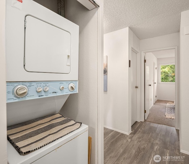 14132 74th Pl NE Unit 16D, Kirkland, WA 98034 - washroom with wood finished floors, stacked washer and clothes dryer, and a textured ceiling